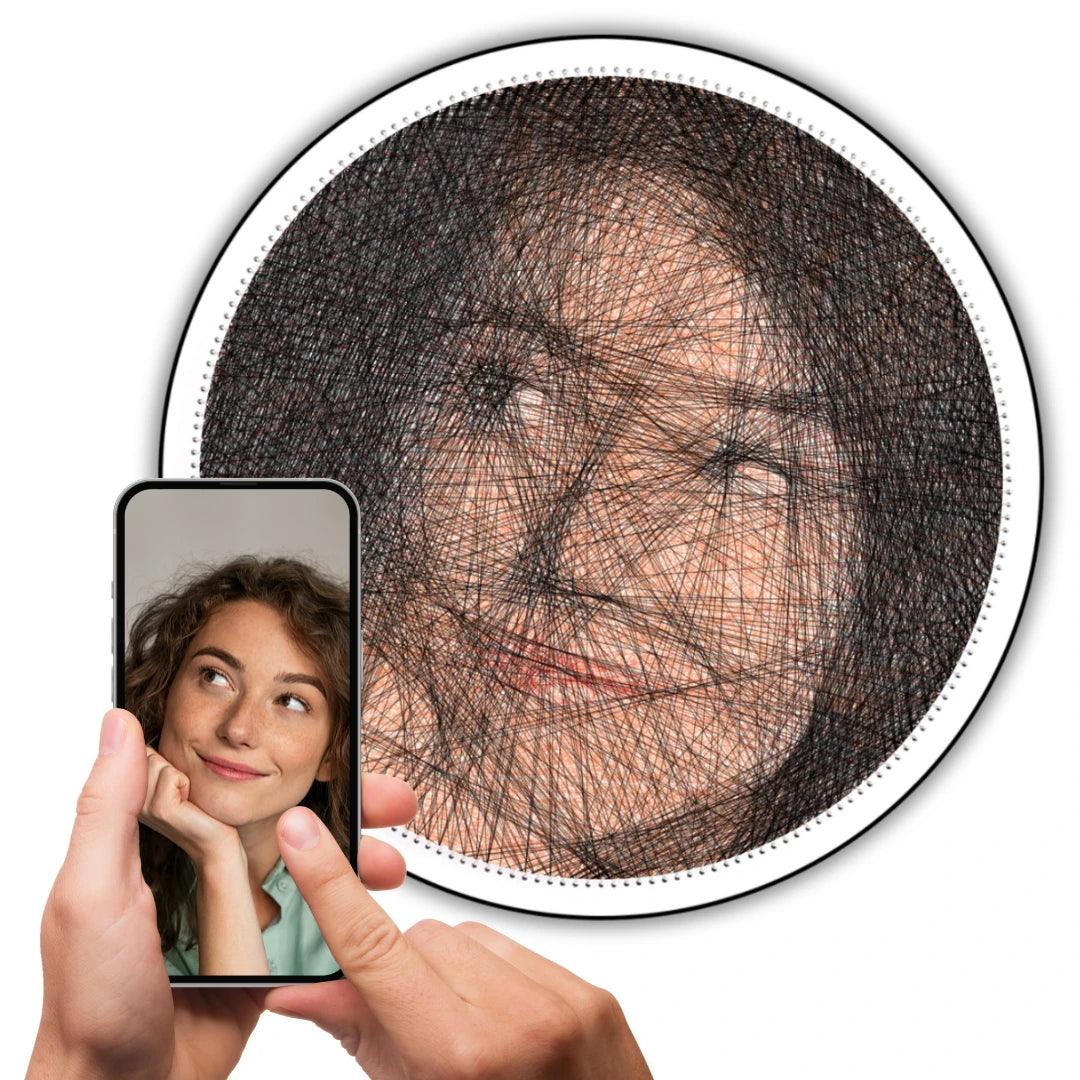 Custom color string art of a girl’s selfie on white board with color strings, original image shown on a phone held in hand