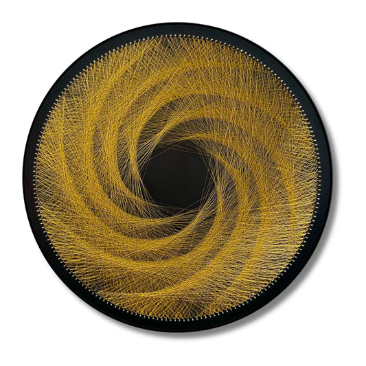 Finished string art design of a spiral from the Gold Collection using black board and gold strings