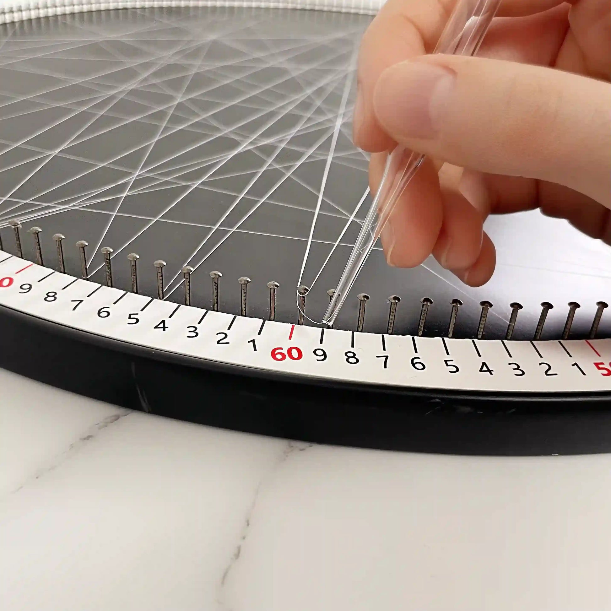 Detailed view of the string art creation process using the DIY Kit from the White Collection