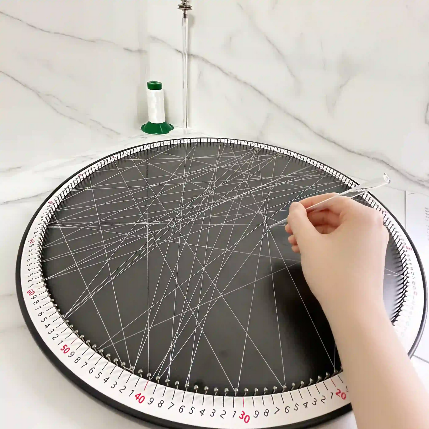 In-progress shot of creating string art using the DIY Kit from the White Collection