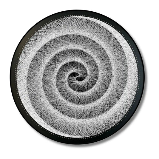 Finished string art design of Hypnotic Swirl from the White Collection using black board and white strings