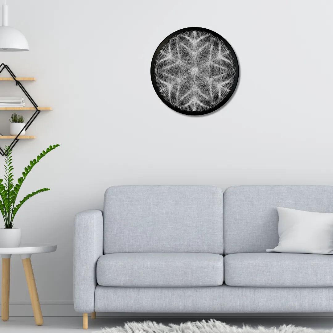 Finished string art design of a snowflake from the White Collection displayed in an interior setting